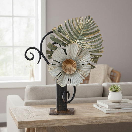 Metal Morph Sculpture handcrafted industrial steel sculpture featuring a rusted metal flower and leaf on a table.