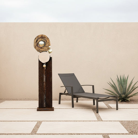 Metal Morph Sculpture Madame Orbit floor sculpture featuring raw steel, metal mesh, and metallic orbs on a patio.