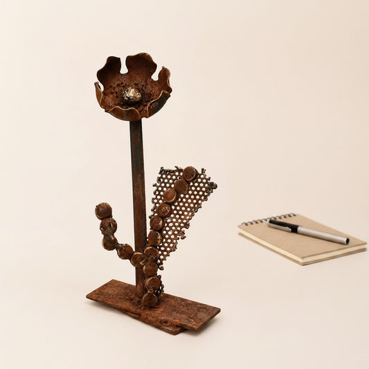 Metal Morph Sculpture handcrafted steel floral art made from recycled industrial scrap metal with a mesh backdrop.