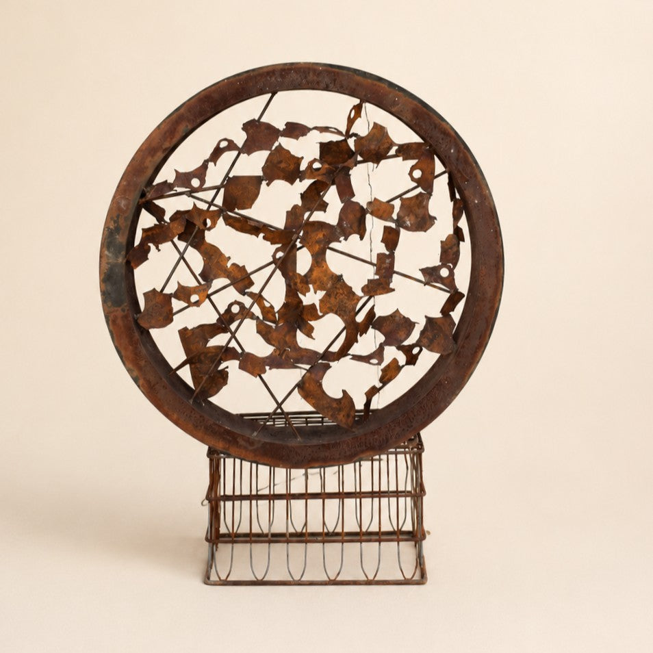 Metal Morph Sculpture Rust & Radius circular steel art piece with a rusted patina finish on a vintage metal base.