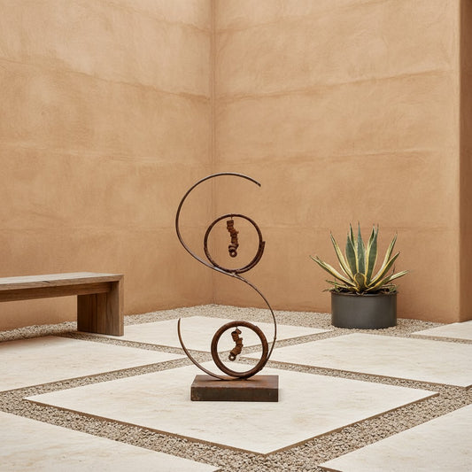 Metal Morph Sculpture Desert Swirl abstract steel sculpture with rusted patina and industrial metal accents on a patio