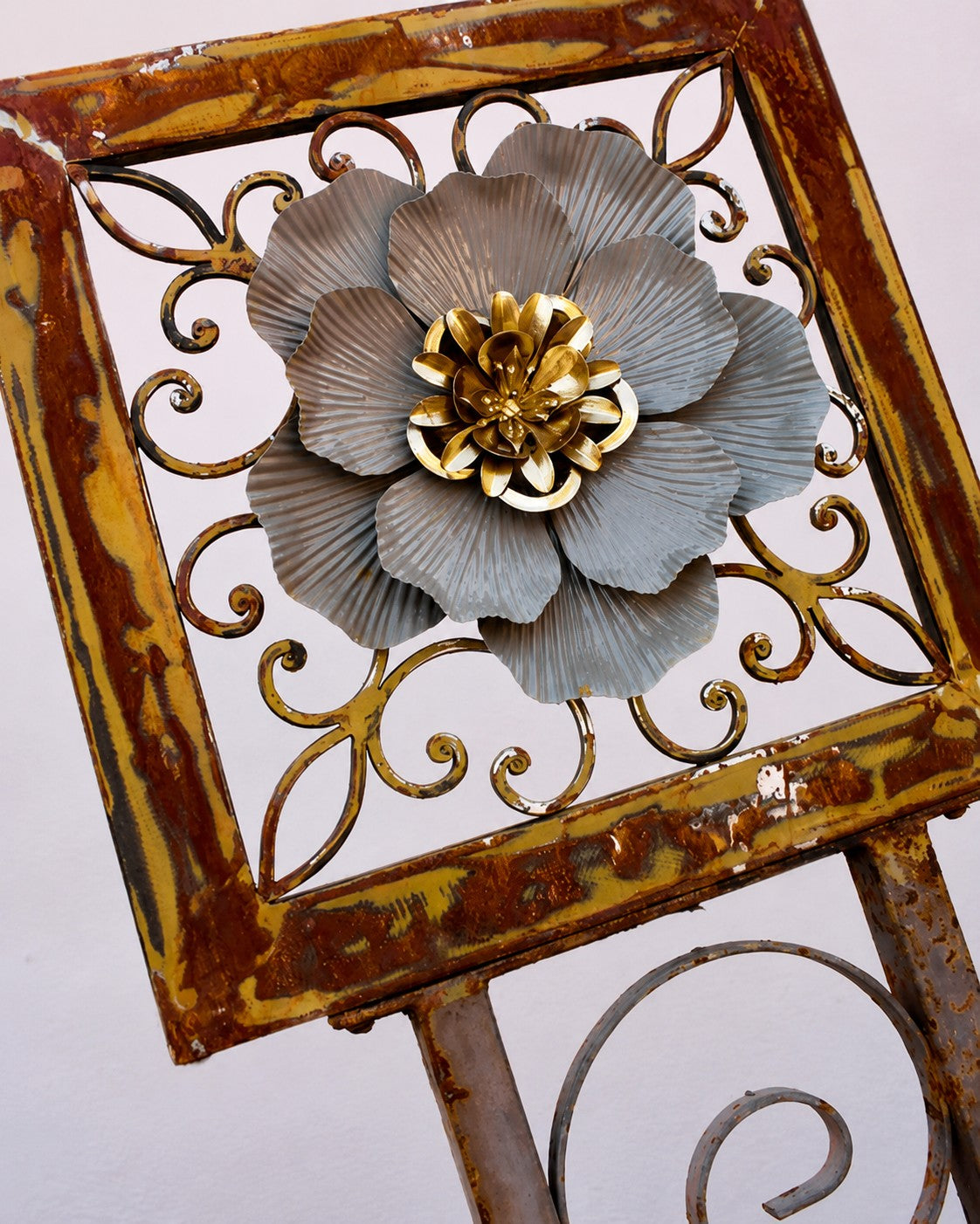 Metal Morph Sculpture The Gated Bloom handcrafted rustic iron gate art with a reclaimed metal flower centerpiece.