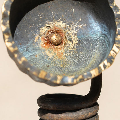 Metal Morph Sculpture handcrafted floral art made from industrial scrap with a weathered patina and coiled base