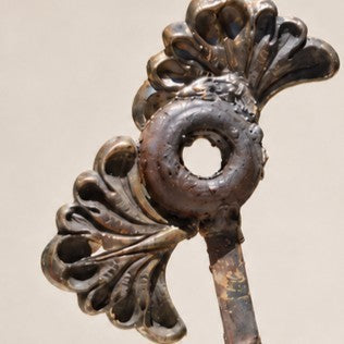 Metal Morph Sculpture Little Bloom handcrafted metal floral sculpture featuring salvaged ornate fan-shaped flower parts.