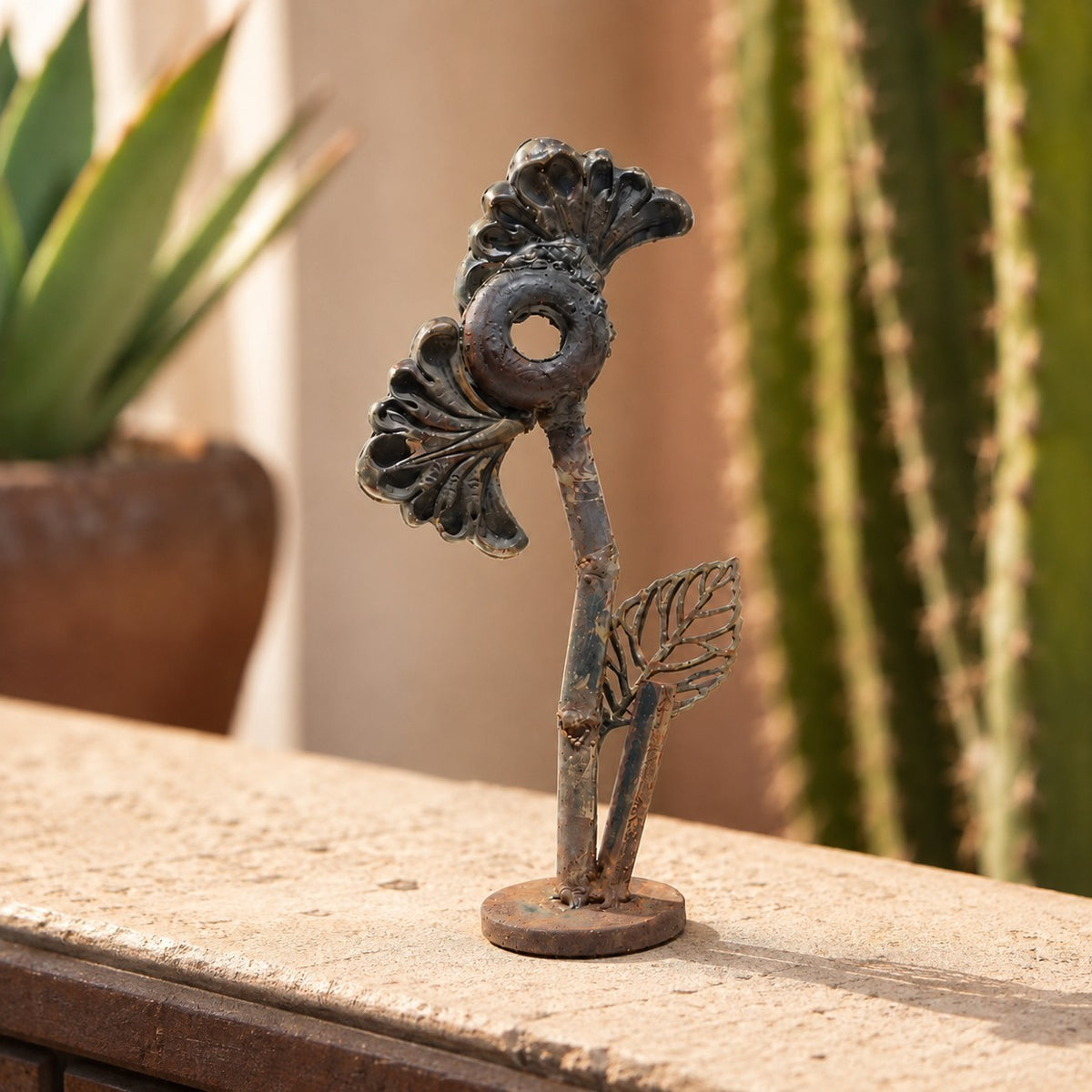 Metal Morph Sculpture Little Bloom handcrafted steel floral sculpture with salvaged fan-shaped flower and leaf detail.