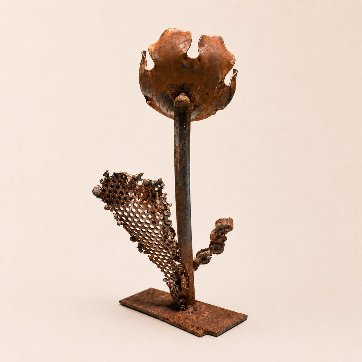 Metal Morph Sculpture handcrafted steel floral art made from salvaged industrial scrap with a mesh leaf and disc bloom