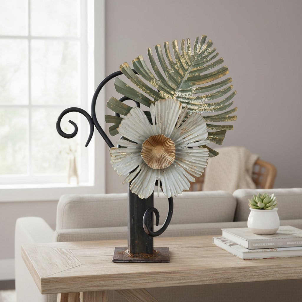 Metal Morph Sculpture handcrafted industrial steel sculpture featuring a rusted metal flower and leaf on a table.