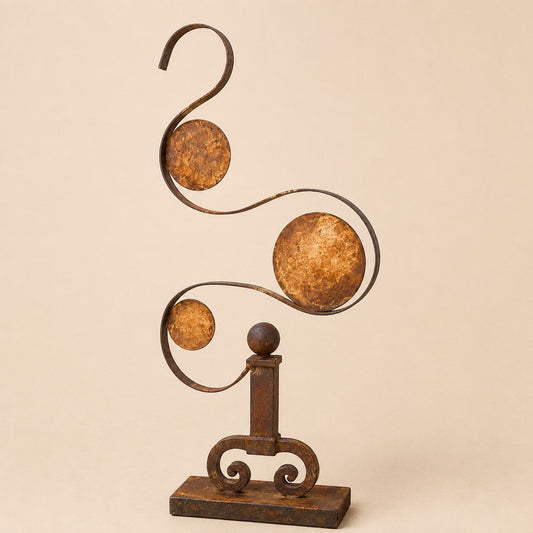 Metal Morph Sculpture Balance in Motion kinetic steel art with antique iron base and circular plates on a beige background
