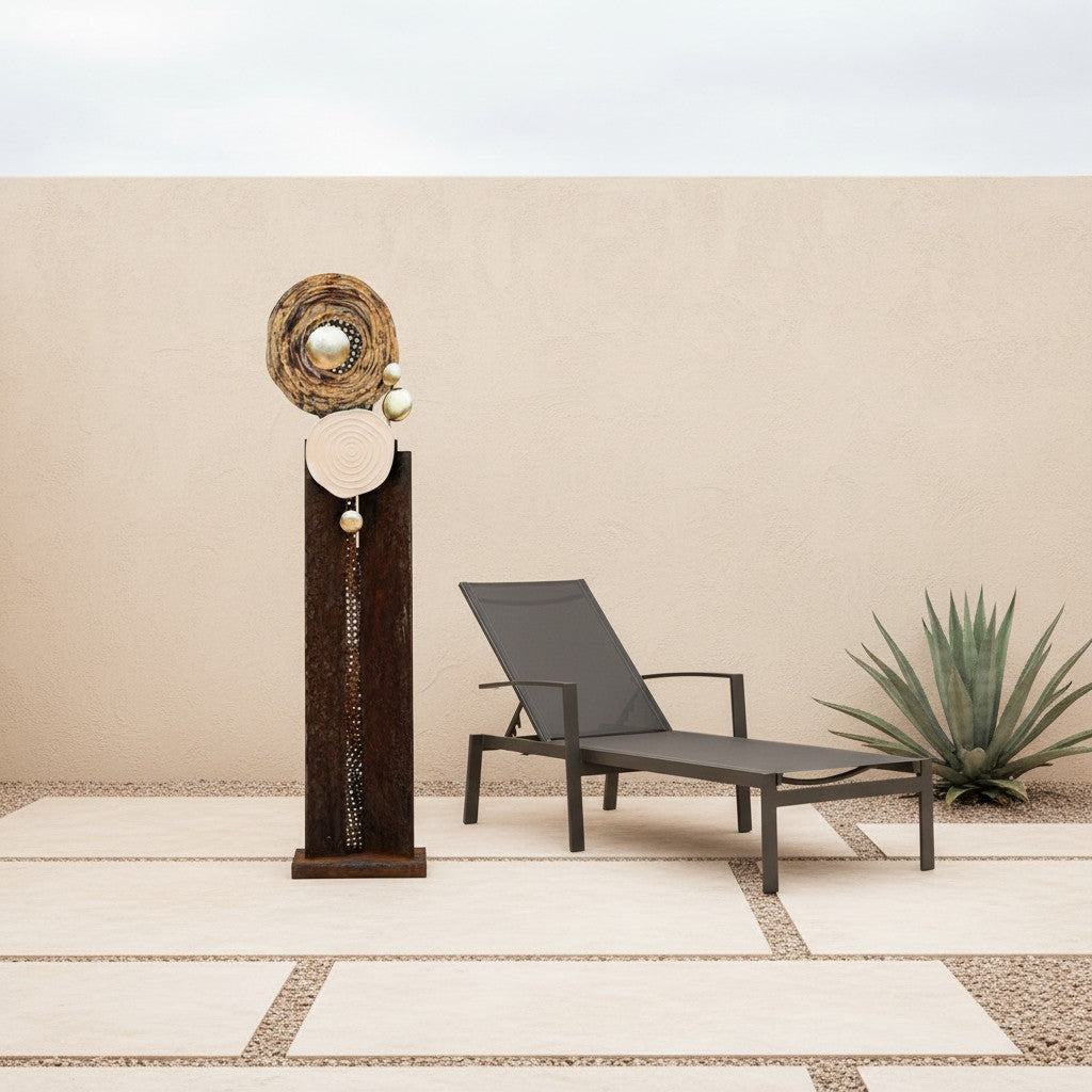 Metal Morph Sculpture Madame Orbit floor sculpture featuring raw steel, metal mesh, and metallic orbs on a patio.