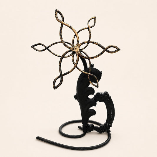 Metal Morph Sculpture Mandala Bloom metal flower art with black and gold patina on a circular base.