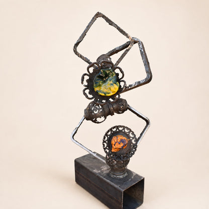 Metal Morph Sculpture Molten Geometry mixed-media art featuring salvaged steel frames and colorful handmade glass.