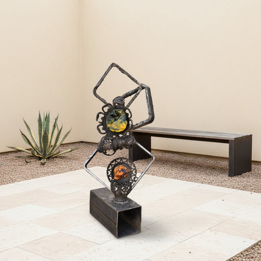 Metal Morph Sculpture Molten Geometry mixed-media art featuring raw steel frames and colorful handmade glass flowers.