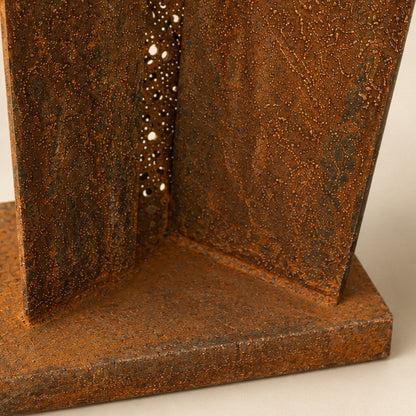 Metal Morph Sculpture Madame Orbit floor sculpture base featuring weathered raw steel and textured metal mesh details.