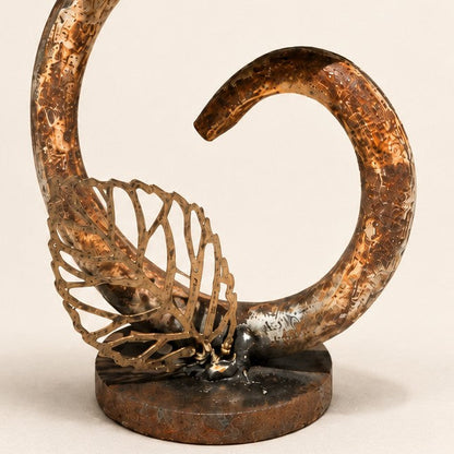Metal Morph Sculpture The Unlikely Flower handcrafted reclaimed metal art piece with a curved stem and leaf detail