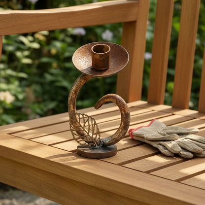 Metal Morph Sculpture handcrafted reclaimed metal flower candle holder with a rustic patina on a wooden bench.