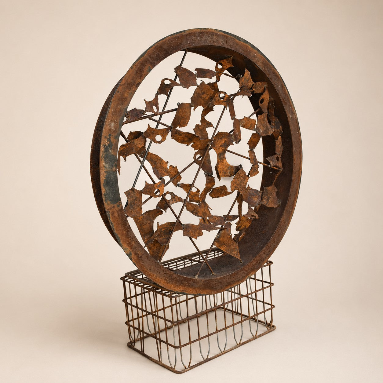 Metal Morph Sculpture Rust & Radius circular steel art with a rusted patina, mounted on a vintage metal milk crate base.