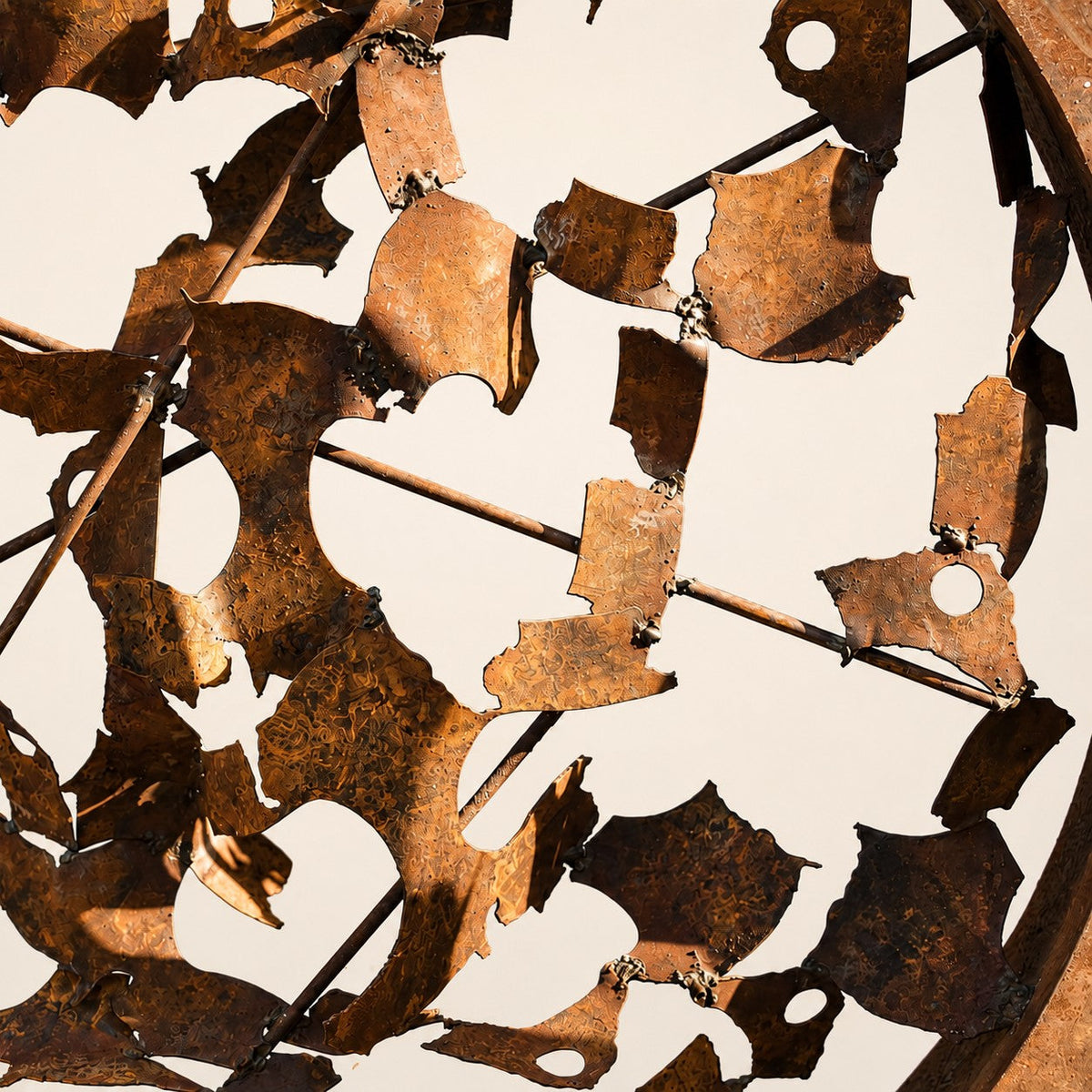 Metal Morph Sculpture Rust & Radius handcrafted circular steel sculpture featuring a textured rusted iron grid pattern
