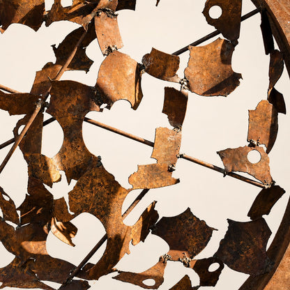 Metal Morph Sculpture Rust & Radius handcrafted circular steel sculpture featuring a textured rusted iron grid pattern