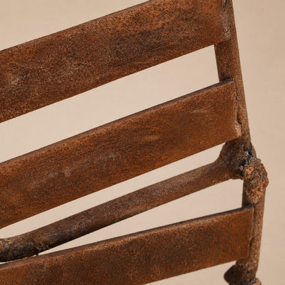 Close-up of Metal Morph Sculpture Starbound showing the textured rustic patina on the industrial steel frame.