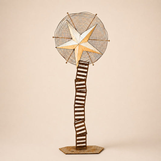 Metal Morph Sculpture Starbound kinetic floor sculpture featuring a rustic metal star and vintage ventilation wheel.
