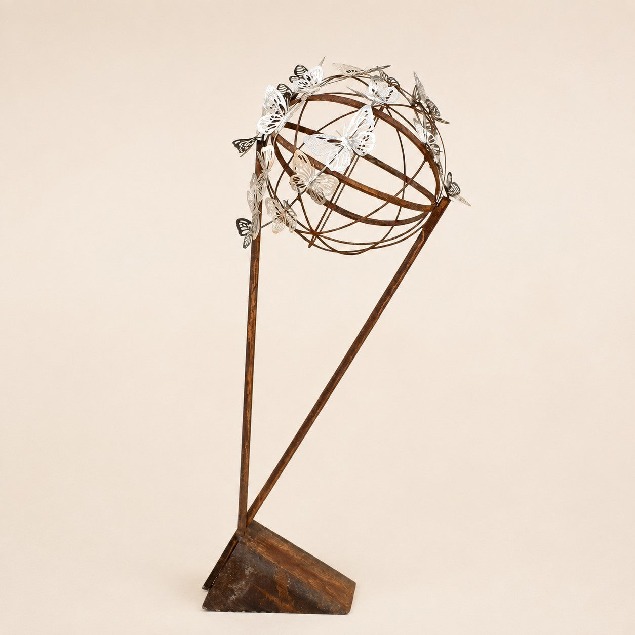 Metal Morph Sculpture Steel Migration abstract art piece featuring a spherical cage with silver butterfly accents