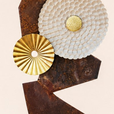 Metal Morph Sculpture Zig Zag Sun featuring rustic steel plates with a textured white and gold metal sun centerpiece.